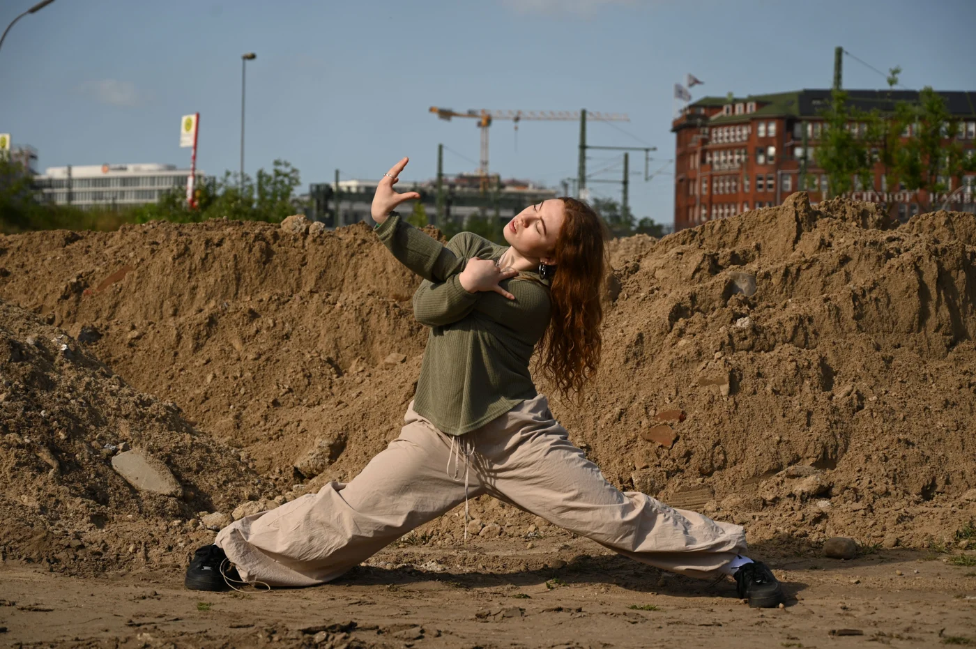 Tara extending into a movement pose outdoors