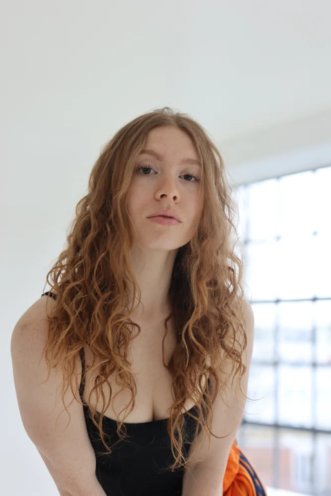 Portrait of Tara in a bright studio