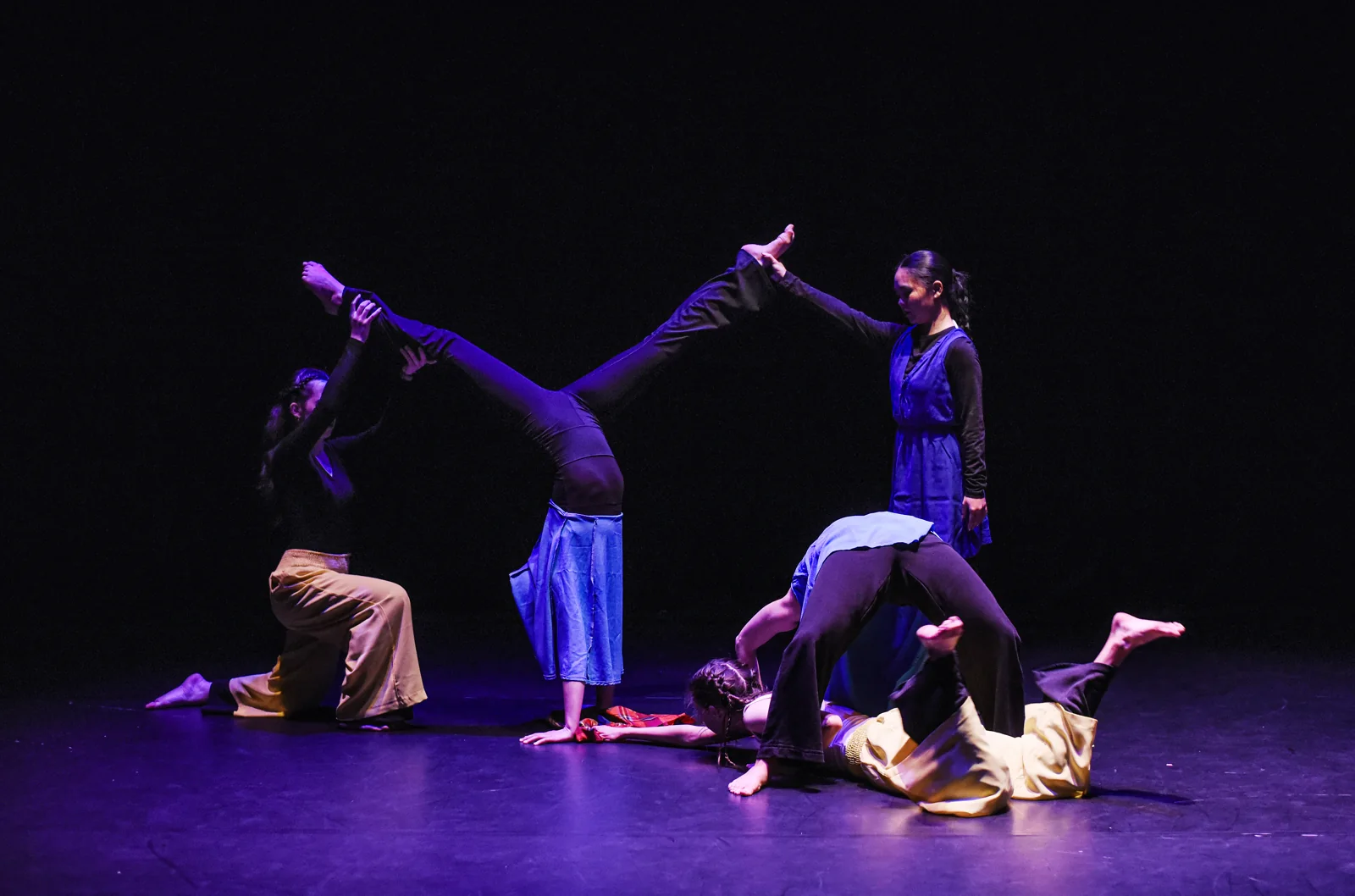 Dancers creating contrasting shapes across the stage