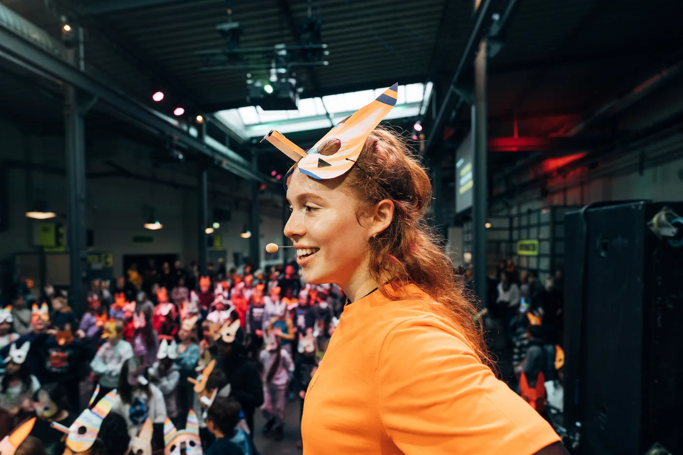 Tara leading a movement activity with a large group of schoolchildren