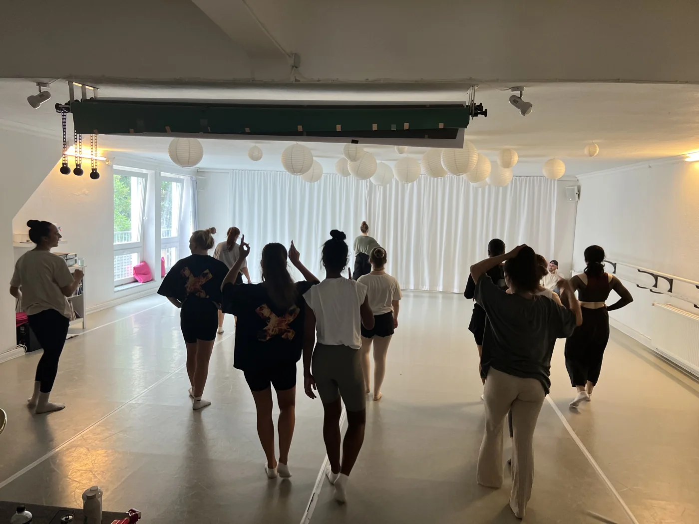 Dancers sharing a movement session in a bright studio