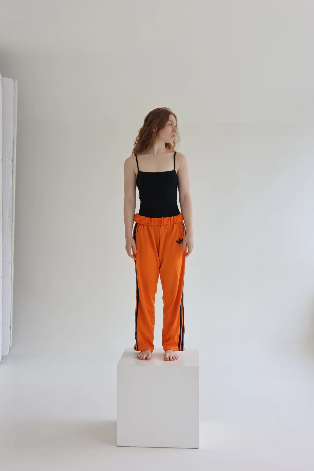 Tara standing on a plinth in a bright studio