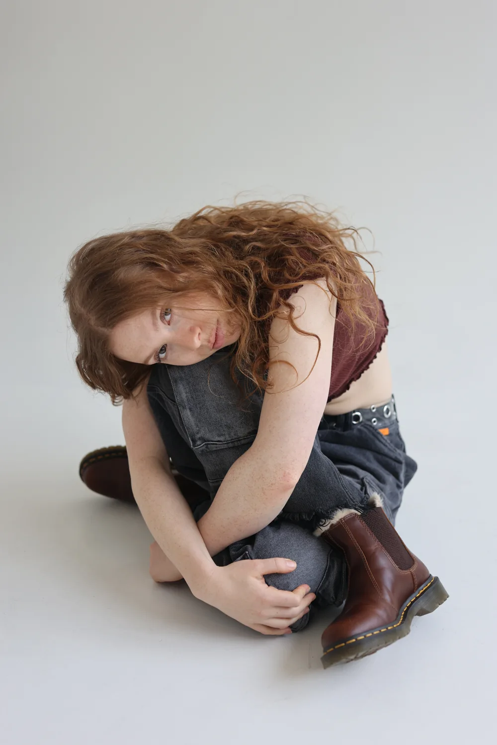 Tara in a seated movement pose in the studio