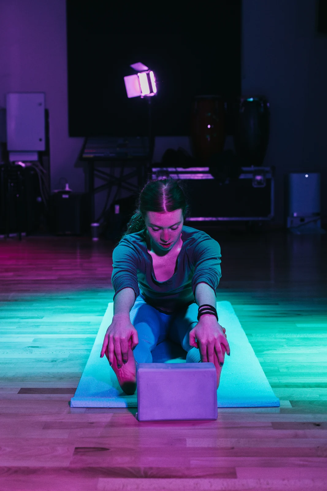 A participant exploring movement on a mat in the Pilates studio